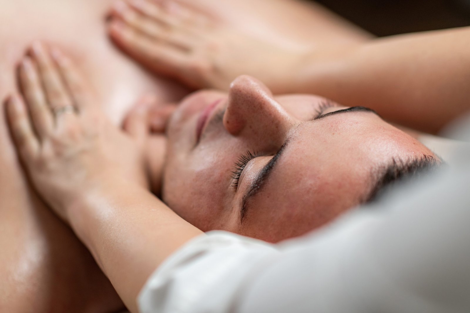 Man enjoying a relaxing massage in a professional salon. The serene atmosphere highlights wellness, stress relief, and therapeutic techniques tailored for mens relaxation.